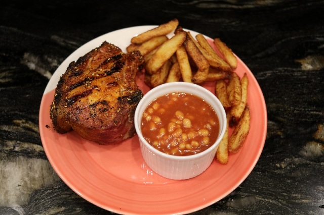 Glazed double-cut pork chops with chips and beans