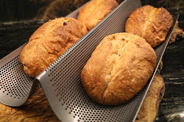Freshly baked small baguettes straight from the oven