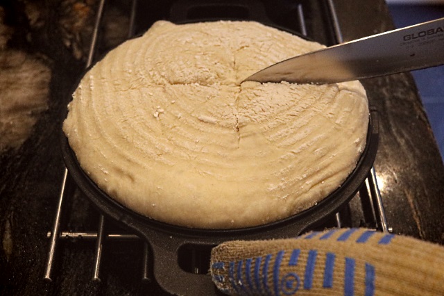 Scoring the dough whilst it is in the Dutch oven lid