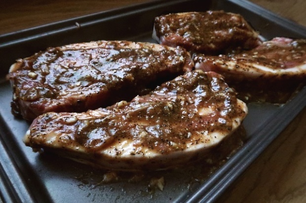 Pork loin steaks marinating in the sauce