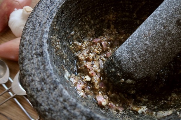 Paste ingredients combined with a pestle and mortar