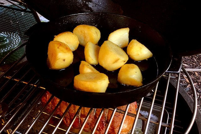 Potatoes roasting above lamb