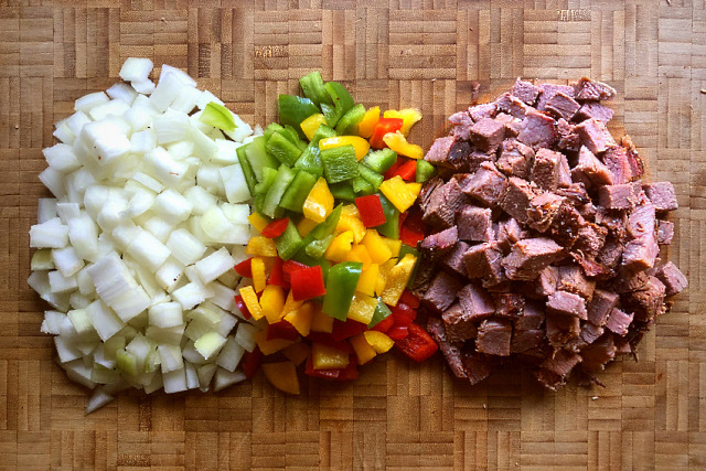 Onion, peppers and brisket cut up and ready to cook