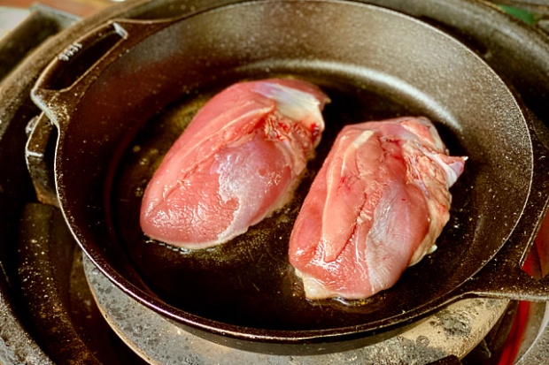 Duck breasts searing in the cast iron pan